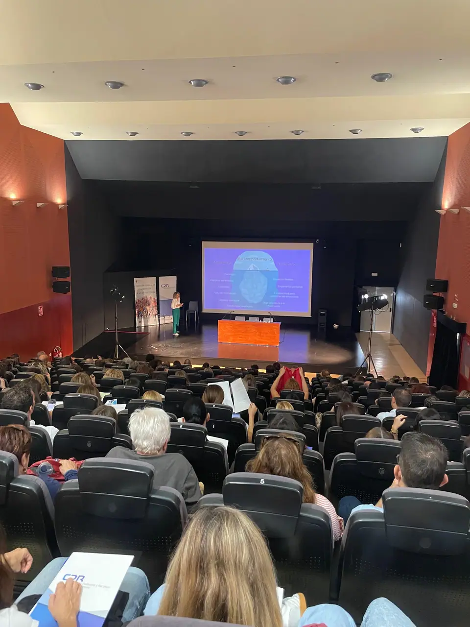 Auditorio lleno durante una charla de Diana